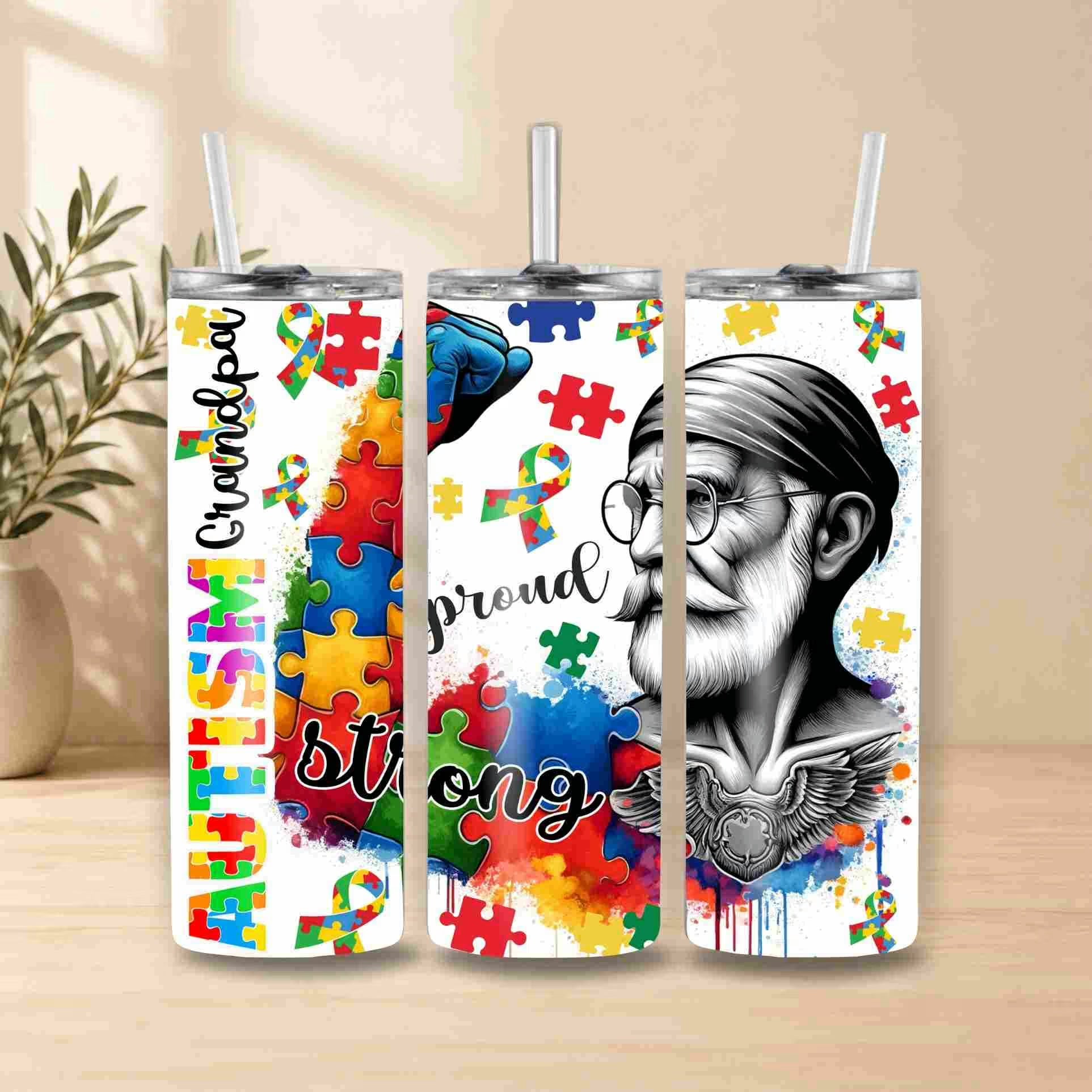 Three tumblers with autism awareness designs featuring colorful puzzles and text on a wooden surface.