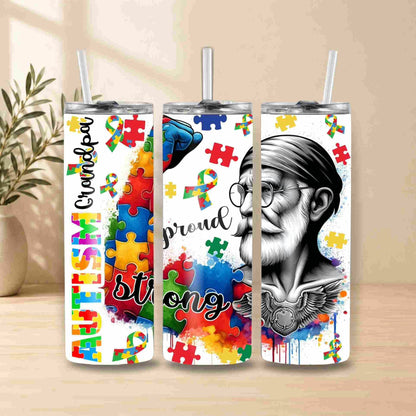 Three tumblers with autism awareness designs featuring colorful puzzles and text on a wooden surface.