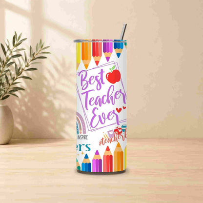 The Best Teacher Ever | 20oz Tumbler features vibrant pencil, apple, heart, and rainbow designs with the text "Best Teacher Ever" on a wooden surface. A plant sits in the background—an ideal, thoughtful teacher gift.