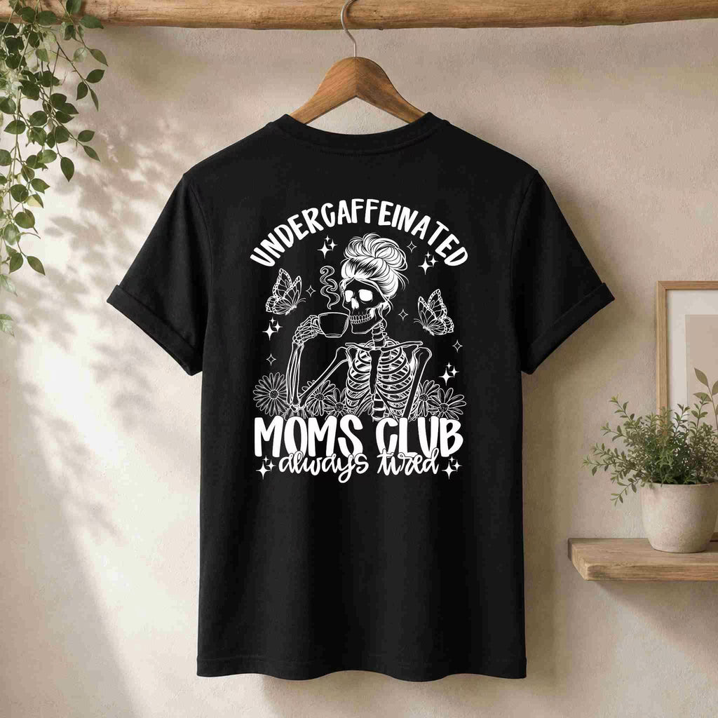 The Undercaffeinated Moms Club Shirt by Becca's Banging Designs LLC features a skeleton mom with a beehive, sunglasses, and coffee cup on the back, plus “Undercaffeinated Moms Club always tired” text. Perfect cute graphic tee for tired moms!.