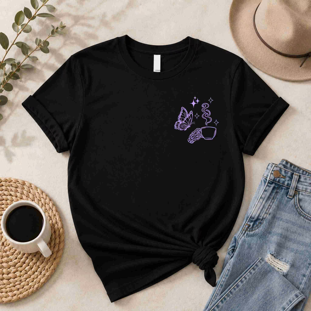 The Undercaffeinated Moms Club Shirt by Becca's Banging Designs LLC—a funny tired mom tee—pairs perfectly with blue jeans, a brown hat, coffee, and greenery for cute graphic t shirt outfit inspiration.