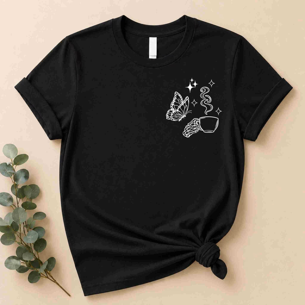 The Undercaffeinated Moms Club Shirt by Becca's Banging Designs LLC is a black tee with a white minimalist butterfly, hand with coffee cup, steam, and stars—perfect for cute t-shirt outfits and fans of women’s graphic tees.