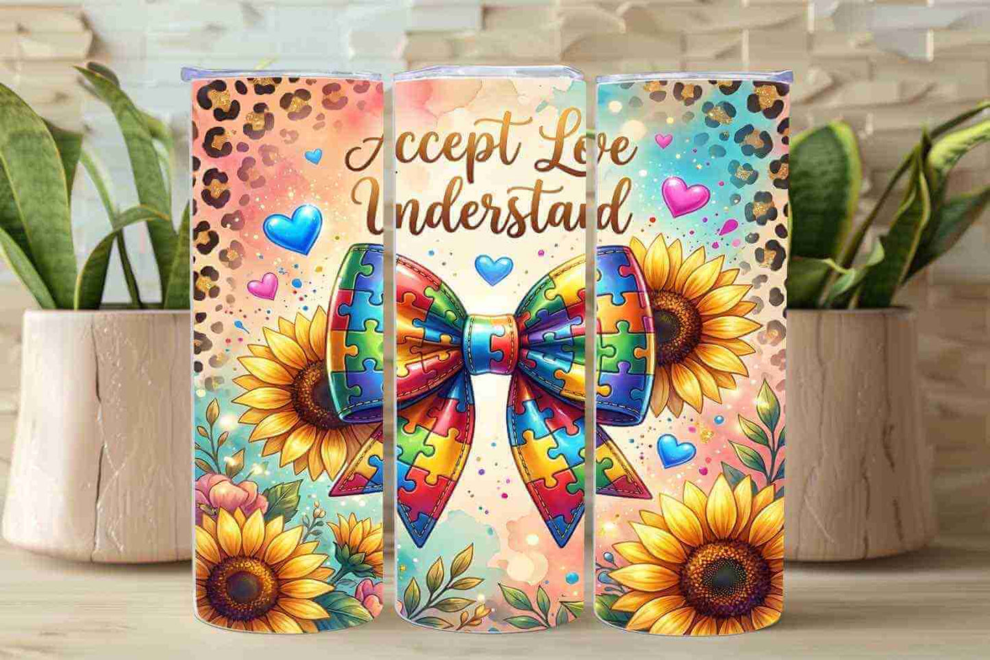 The 20oz Autism Awareness Sunflower Tumbler by Becca's Banging Designs LLC features sunflowers, hearts, a puzzle bow, “Accept Love Understand” script, plants in the background, and a leopard print border on stainless steel.