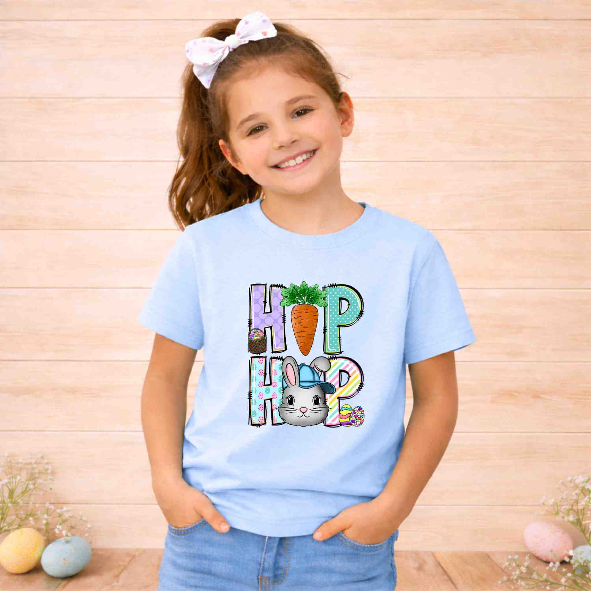 Youth wearing Easter Bunny HOP shirt with pastel letters and a cute bunny graphic for spring celebrations.