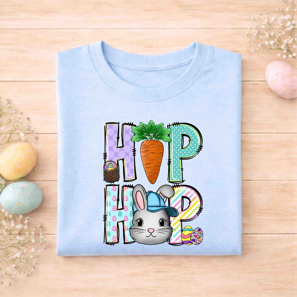 Easter Bunny HOP shirt design featuring a playful bunny, colorful letters, and carrot detail on a light blue youth tee.
