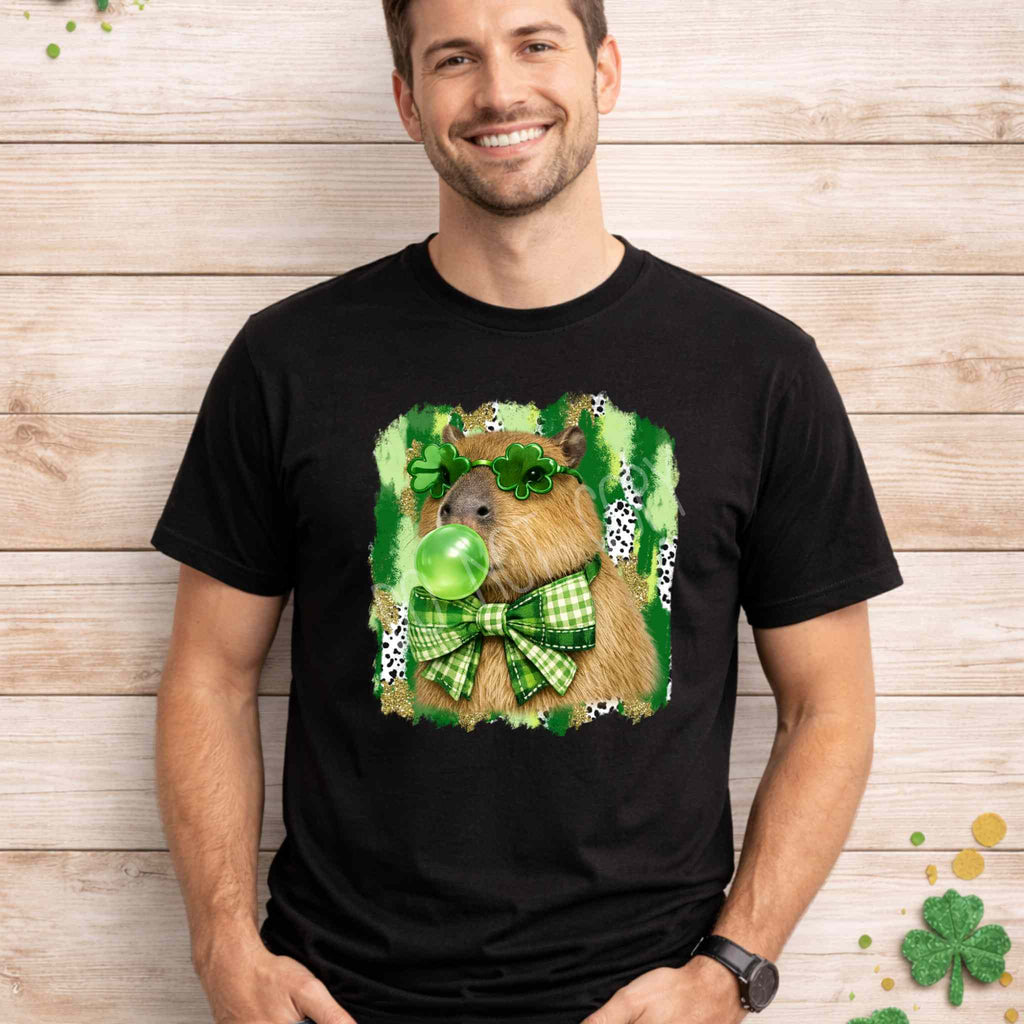 St. Patricks Day Capybara Shirt featuring shamrock glasses and a green bow tie, perfect for festive celebrations.