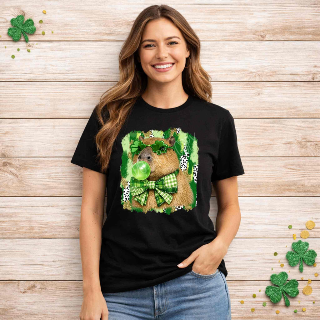 St. Patricks Day Capybara Shirt featuring a cute animal design with shamrock glasses and a decorated bow