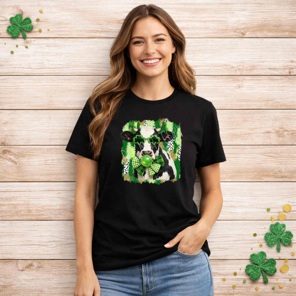 St. Patricks Day Cow Shirt with Shamrock Glasses design worn by a smiling model against a wooden background.