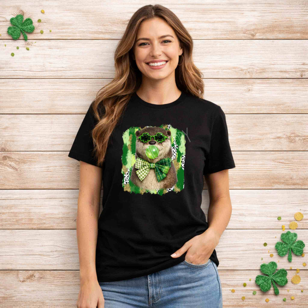 Woman modeling St. Patricks Day Otter Shirt with shamrock glasses and a green bow on a black background.