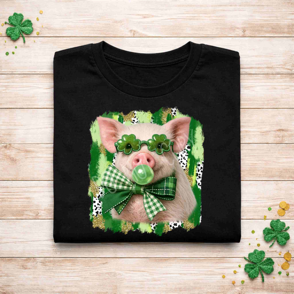 St. Patricks Day pig shirt featuring a pig with shamrock glasses and a plaid bow on a black tee.