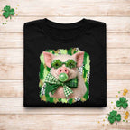 St. Patricks Day pig shirt featuring a pig with shamrock glasses and a plaid bow on a black tee.