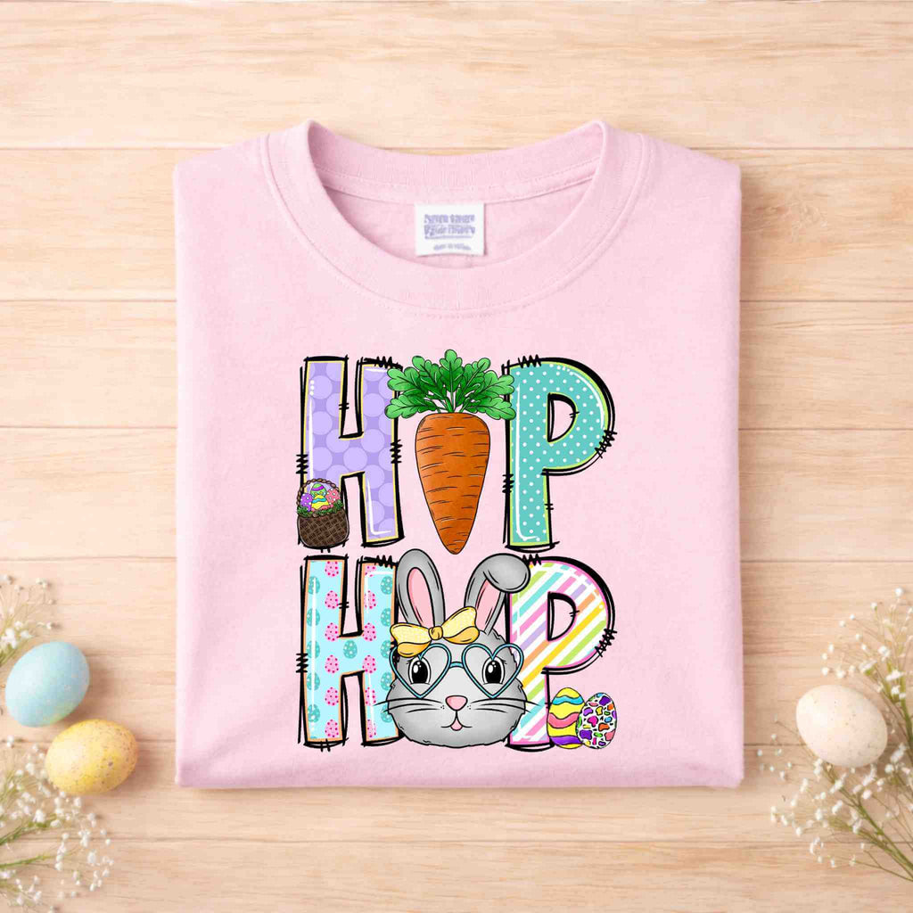 Easter Bunny HOP shirt design featuring a cute bunny, colorful letters, and a carrot detail on a pink youth tee.