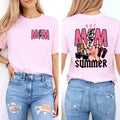A woman wears the Hot Mom Summer Tee – Trendy Mama Graphic Shirt by Becca's Banging Designs LLC, featuring bold “MOM” on the front and playful summer graphics on the back, paired with ripped blue jeans for a casual vibe.