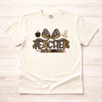 Leopard Love Teacher T-Shirt featuring a fun leopard bow, apple, pencil, and paper clip design for teachers.