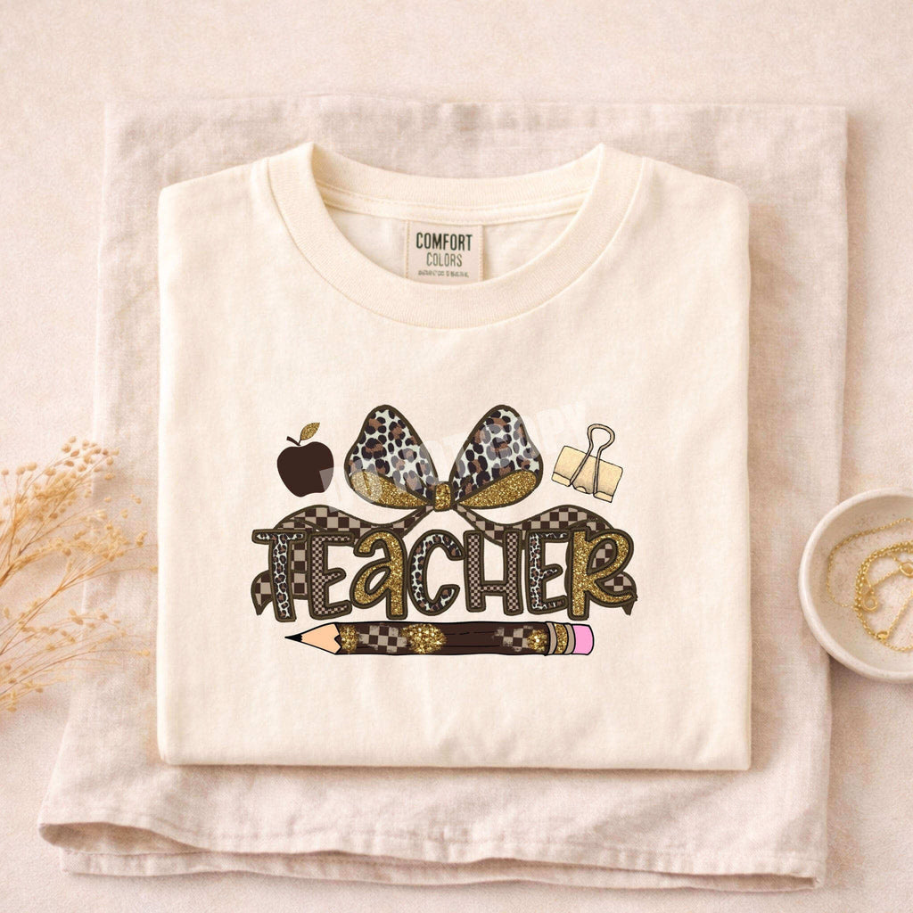 Leopard Love Teacher T-Shirt featuring a stylish design with a leopard print bow and teaching icons.