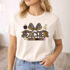Leopard Love Teacher T-Shirt featuring leopard design, teacher elements, and bow detail.