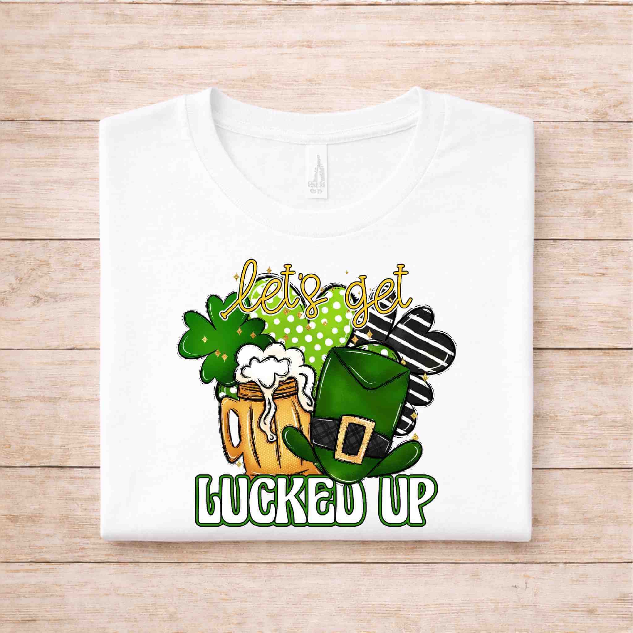 St. Patricks Day shirt featuring a graphic of a beer mug, shamrocks, and a leprechaun hat with text 'let's get lucked up'.