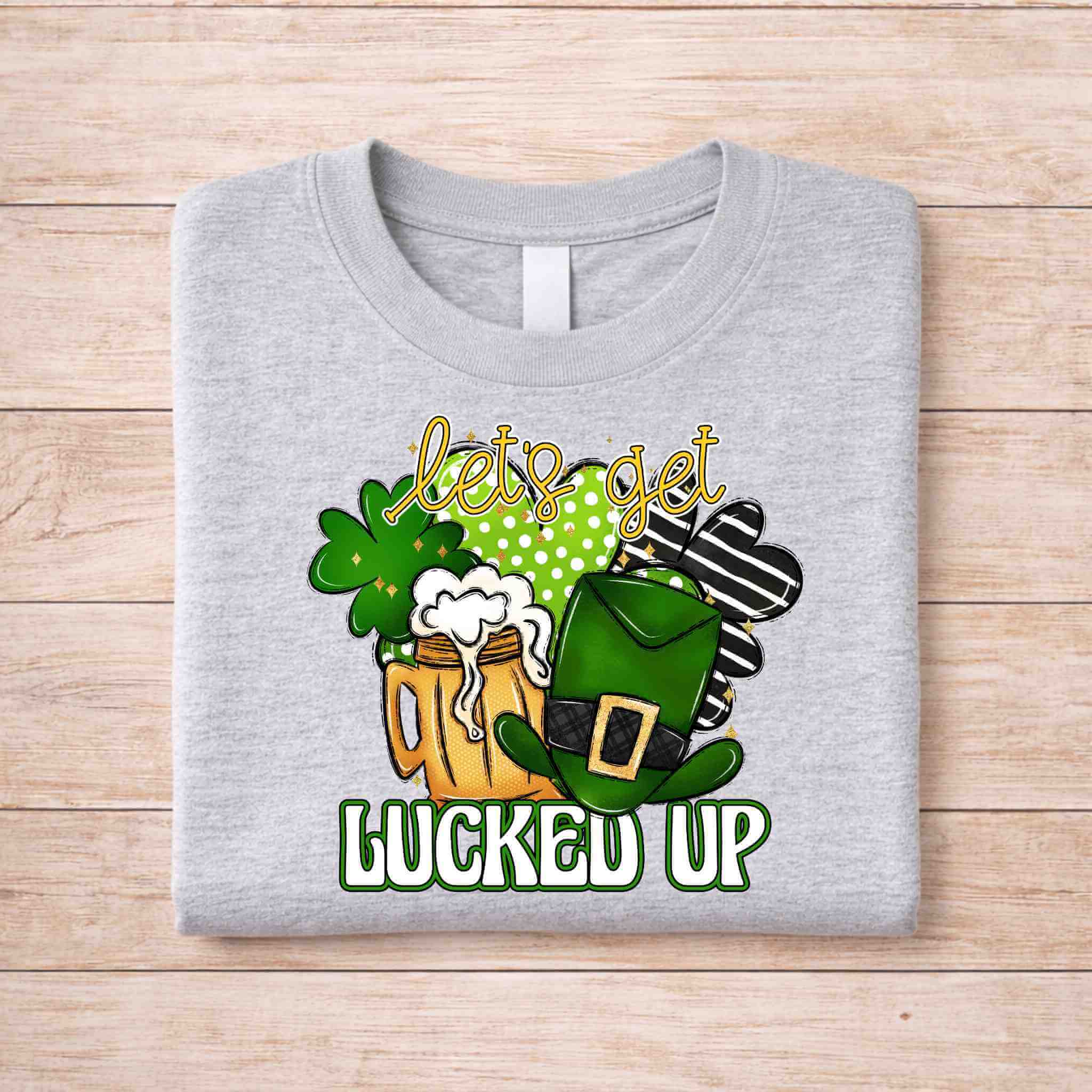 St. Patricks Day shirt featuring a frothy beer mug, lucky shamrocks, and leprechaun hat with text 'let's get lucked up'.