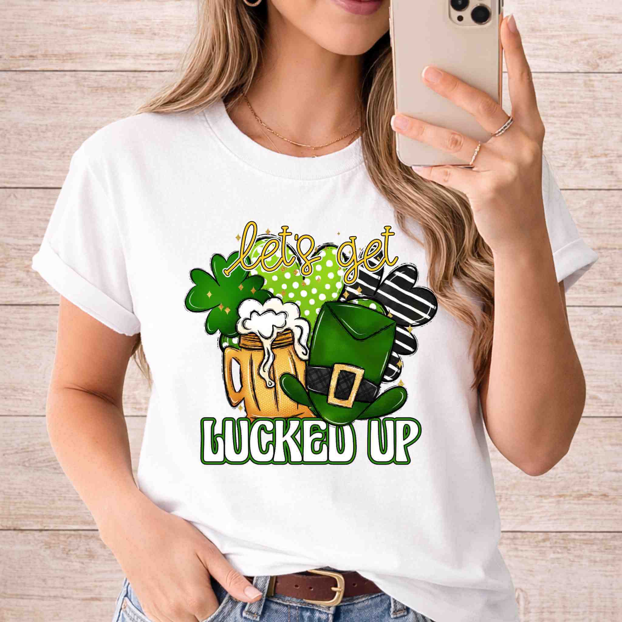 St. Patricks Day shirt featuring a frothy beer mug, shamrocks, and leprechaun hat with the phrase 'let's get lucked up'.