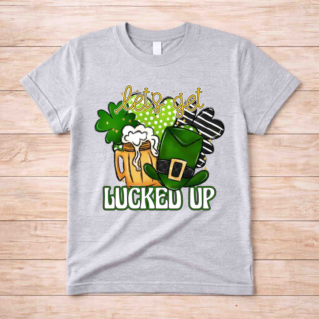 St. Patricks Day shirt featuring frothy beer mugs, shamrocks, and a leprechaun hat with 'Let's Get Lucked Up' design.