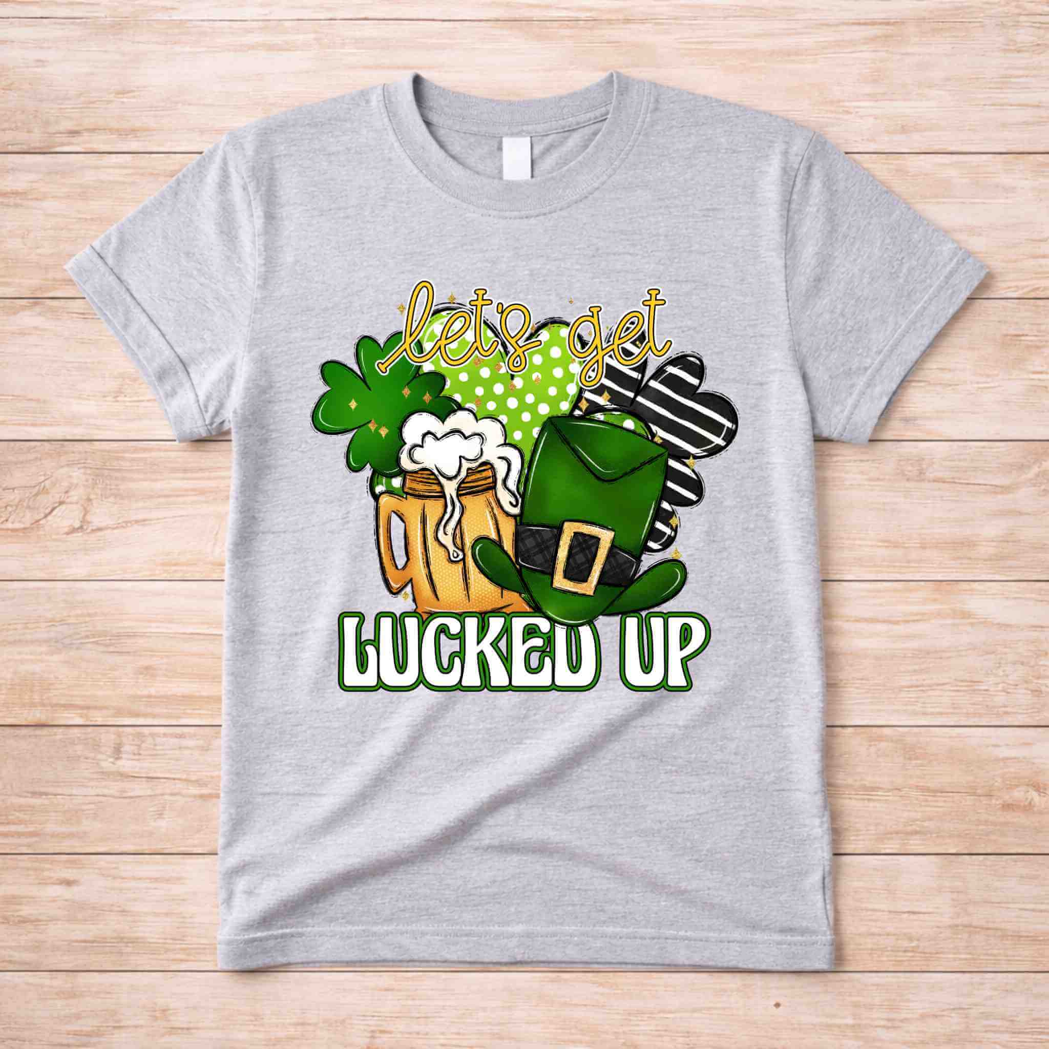 St. Patricks Day shirt featuring frothy beer mugs, shamrocks, and a leprechaun hat with 'Let's Get Lucked Up' design.