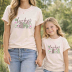 St. Patricks Day matching t-shirt set for Mama and Mini featuring floral design and shamrock accents.