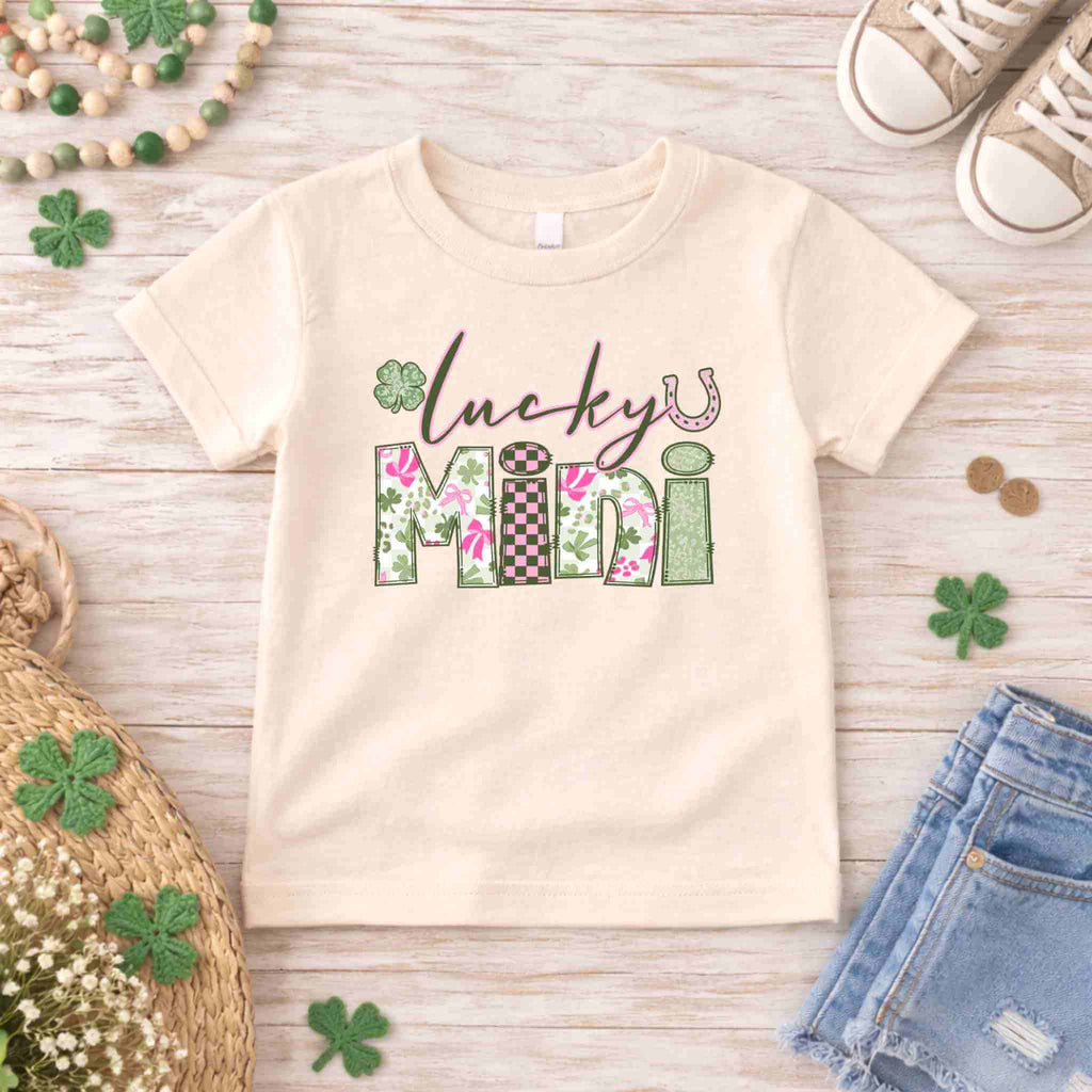 Lucky Mini T-Shirt for St. Patricks Day with floral and checkered design on wood background.