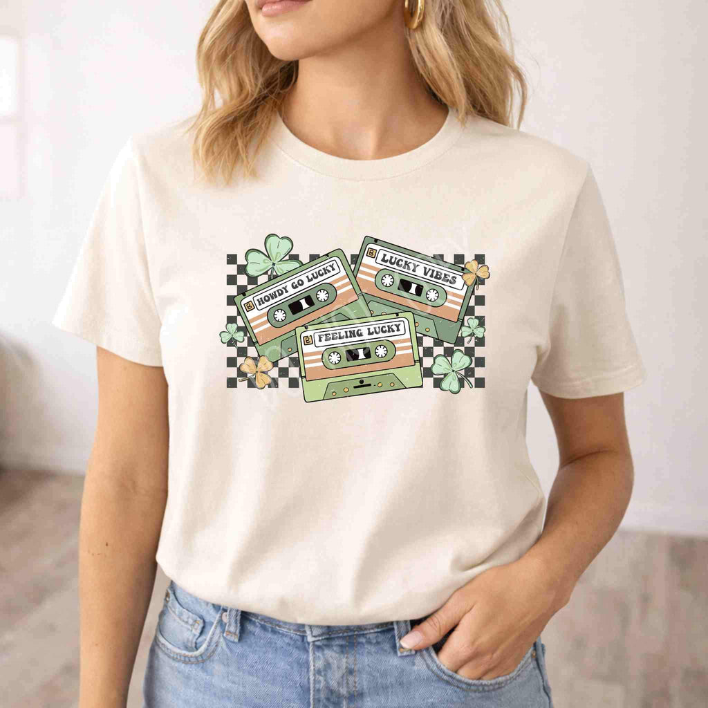 St. Patricks Day shirt featuring retro cassette graphic and shamrock details on a light-colored tee.