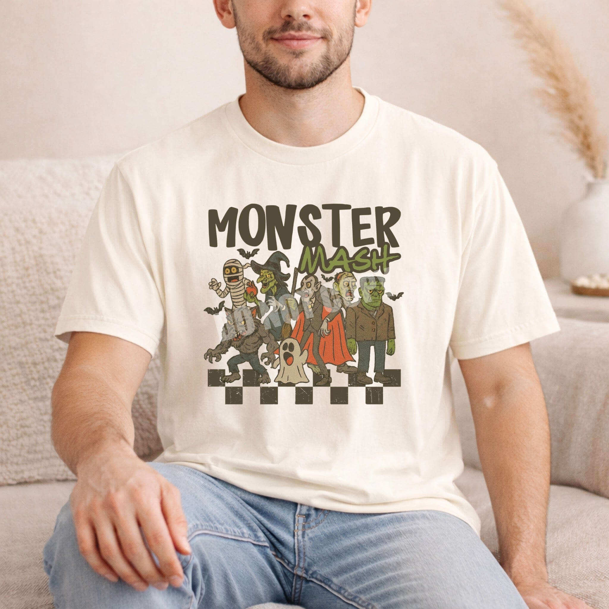 Man wearing a Monster Mash T-Shirt featuring classic Halloween characters in a playful design.