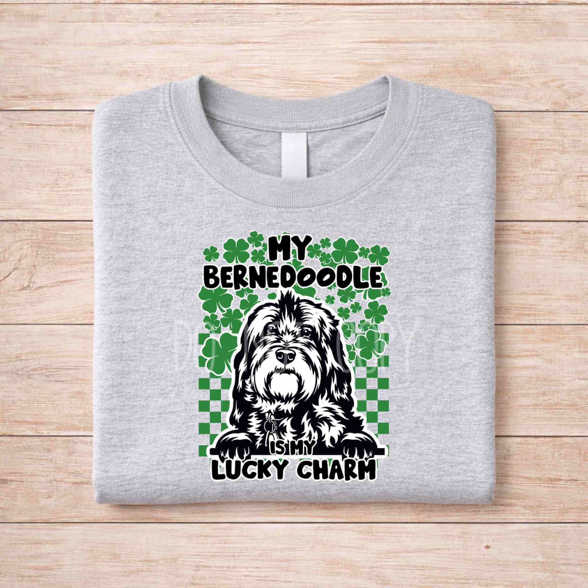 St Patricks Day dog lover shirt with the text My Bernedoodle Is My Lucky Charm and shamrock design on a gray background.