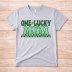 St. Patricks Day One Lucky MUM tee shirt with retro lettering and shamrock accents on a gray background.