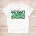 St. Patricks Day One Lucky Auntie tee shirt with green shamrock accents on a white background.