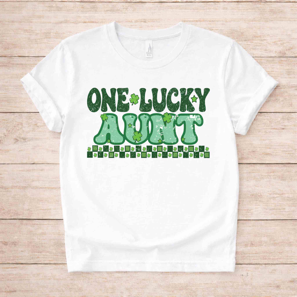 St. Patricks Day One Lucky Aunt tee with retro lettering and shamrock accents on a white background