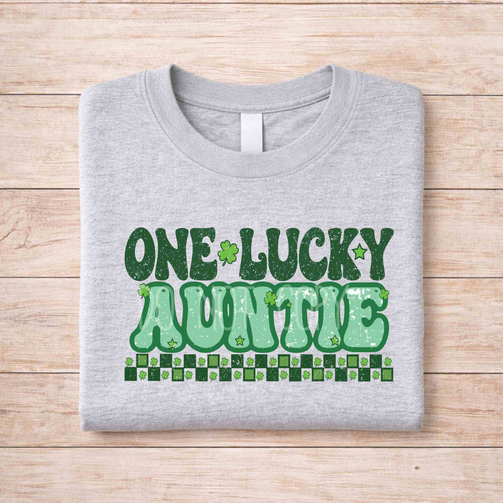 St. Patricks Day One Lucky Auntie tee with retro lettering and shamrock accents on a gray shirt.
