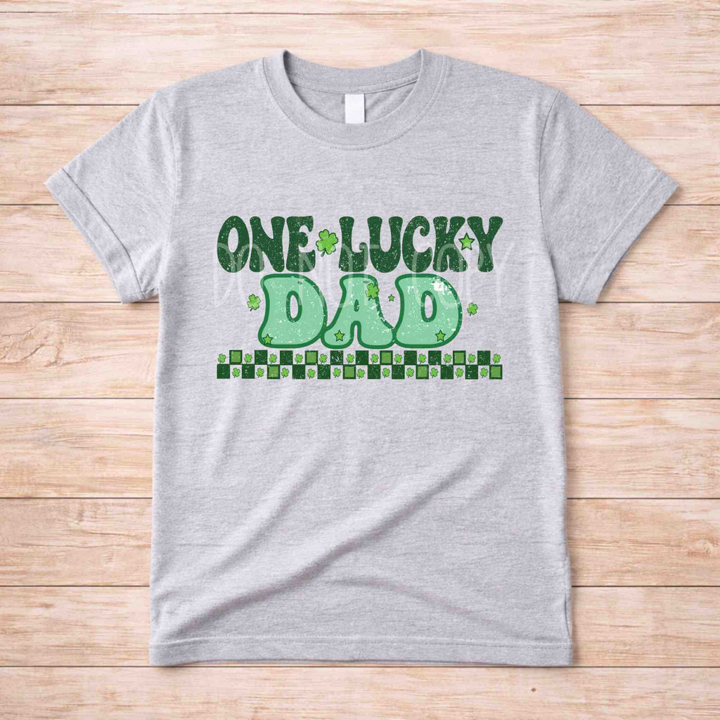 St. Patricks Day matching tee featuring distressed lettering and shamrock accents for family gatherings.