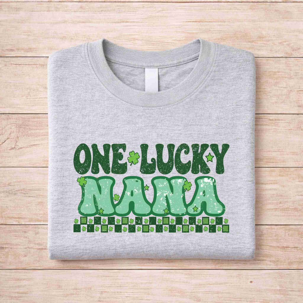 St. Patricks Day matching tee featuring green retro text 'One Lucky Nana' on a gray shirt.