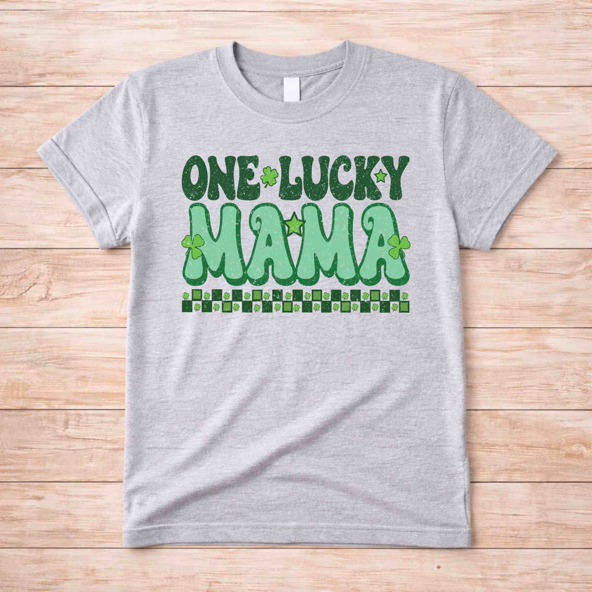 St. Patricks Day shirt featuring retro lettering saying One Lucky Mama with shamrock accents.