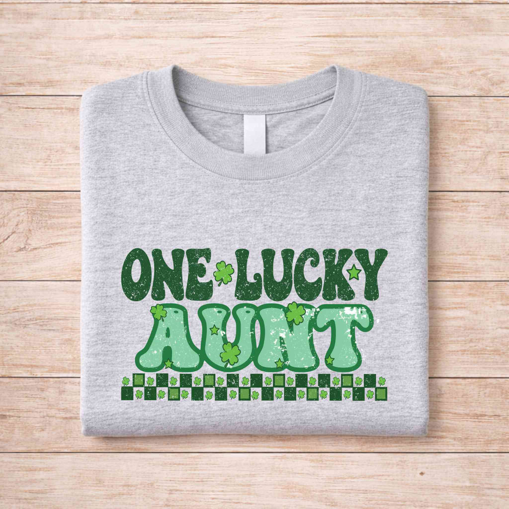 St. Patricks Day One Lucky Aunt t-shirt in gray with green retro lettering and shamrock accents.