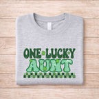 St. Patricks Day One Lucky Aunt t-shirt in gray with green retro lettering and shamrock accents.