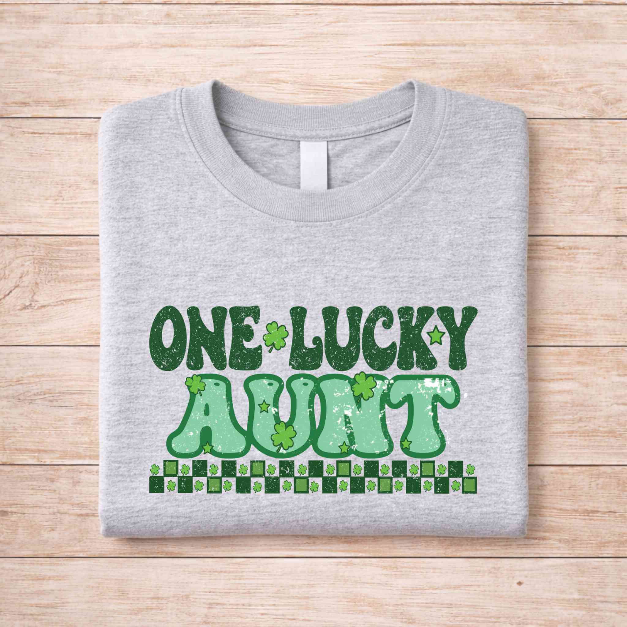 St. Patricks Day One Lucky Aunt t-shirt in gray with green retro lettering and shamrock accents.