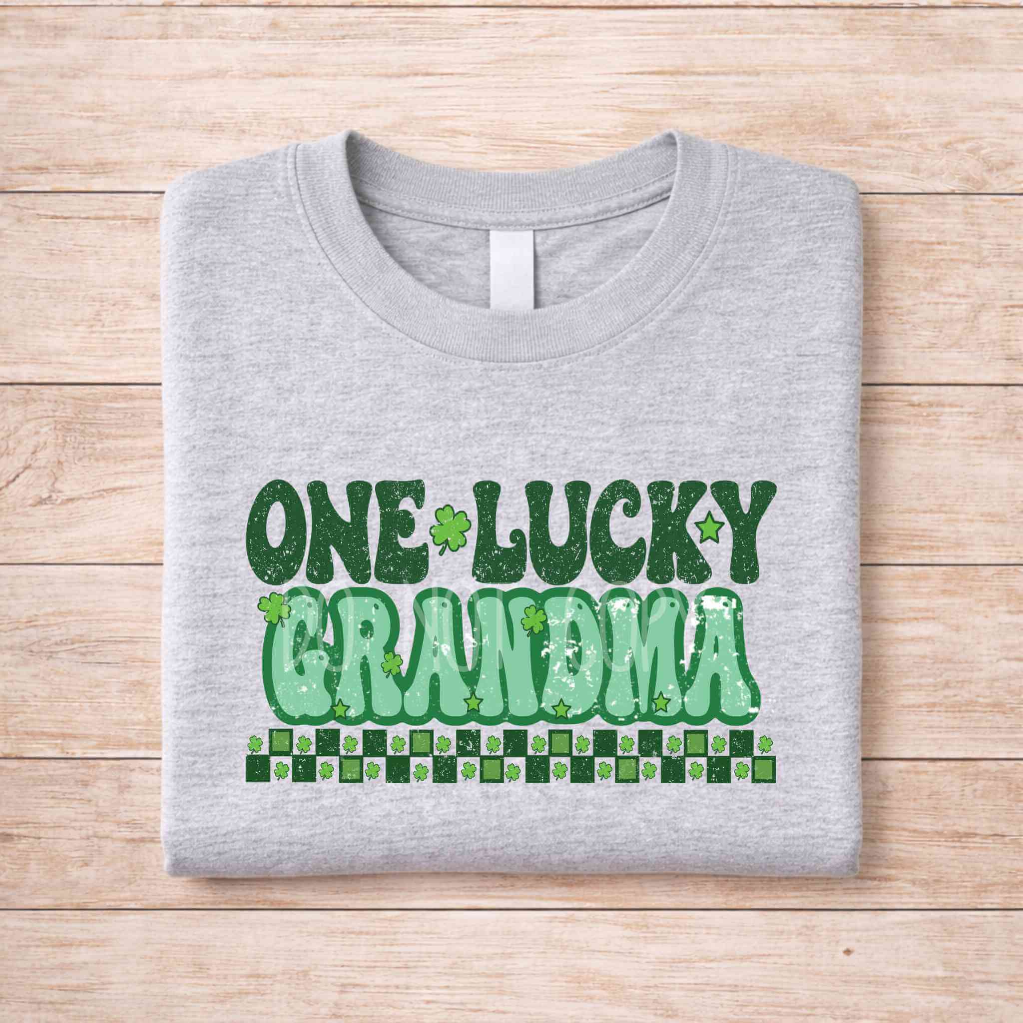 St. Patricks Day matching tee featuring retro lettering for One Lucky Grandma on a gray shirt.