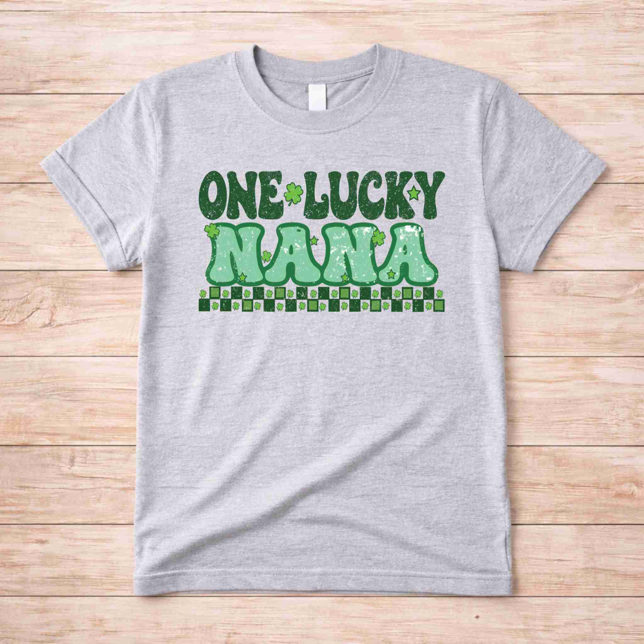 St. Patricks Day One Lucky Nana tee with retro lettering and shamrock accents on gray fabric.
