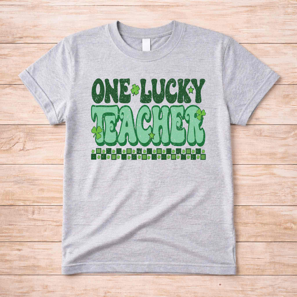 St. Patricks Day Teacher T-Shirt with One Lucky Teacher graphic and shamrocks in green on a grey tee.