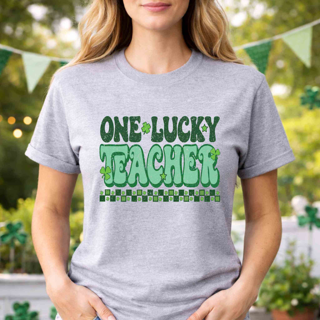 St. Patricks Day Teacher T-Shirt featuring a cute shamrock graphic and retro lettering for festive classroom style.