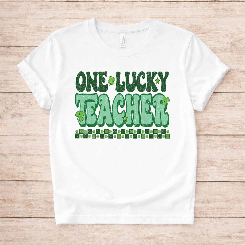 St. Patricks Day Teacher T-Shirt featuring cute shamrock graphic and bold retro lettering on a white background.