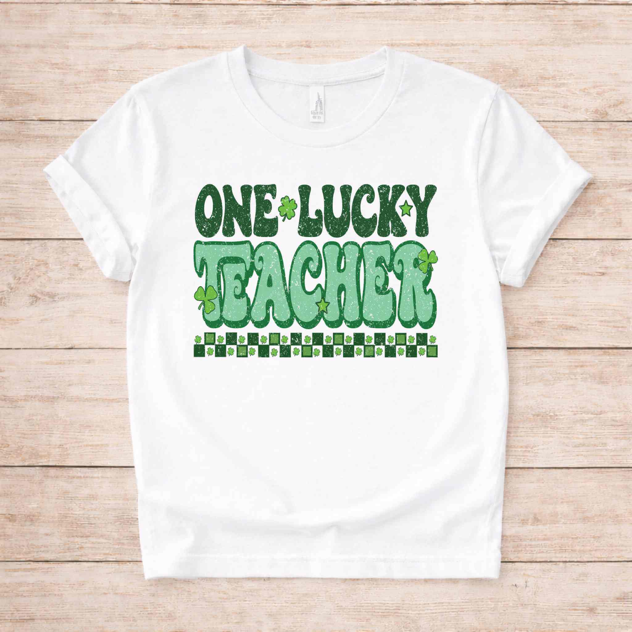 St. Patricks Day Teacher T-Shirt featuring cute shamrock graphic and bold retro lettering on a white background.