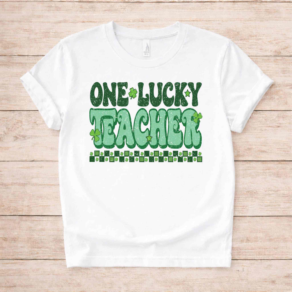 St. Patricks Day Teacher T-Shirt featuring bold green lettering and shamrock graphics on a white tee.