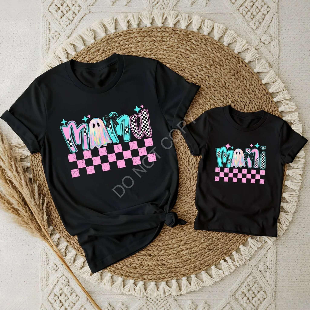 Pastel mommy and me t-shirt set featuring matching black tees with colorful 'Mama' design against a checkerboard background.