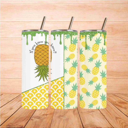 Three Pineapple IYKYK | 20oz Tumblers from Becca's Banging Designs, featuring yellow pineapples and green leaves with metal straws, stand on wood. One tumbler reads “If you know you know!!”—a playful, aesthetic addition to your drinkware collection.